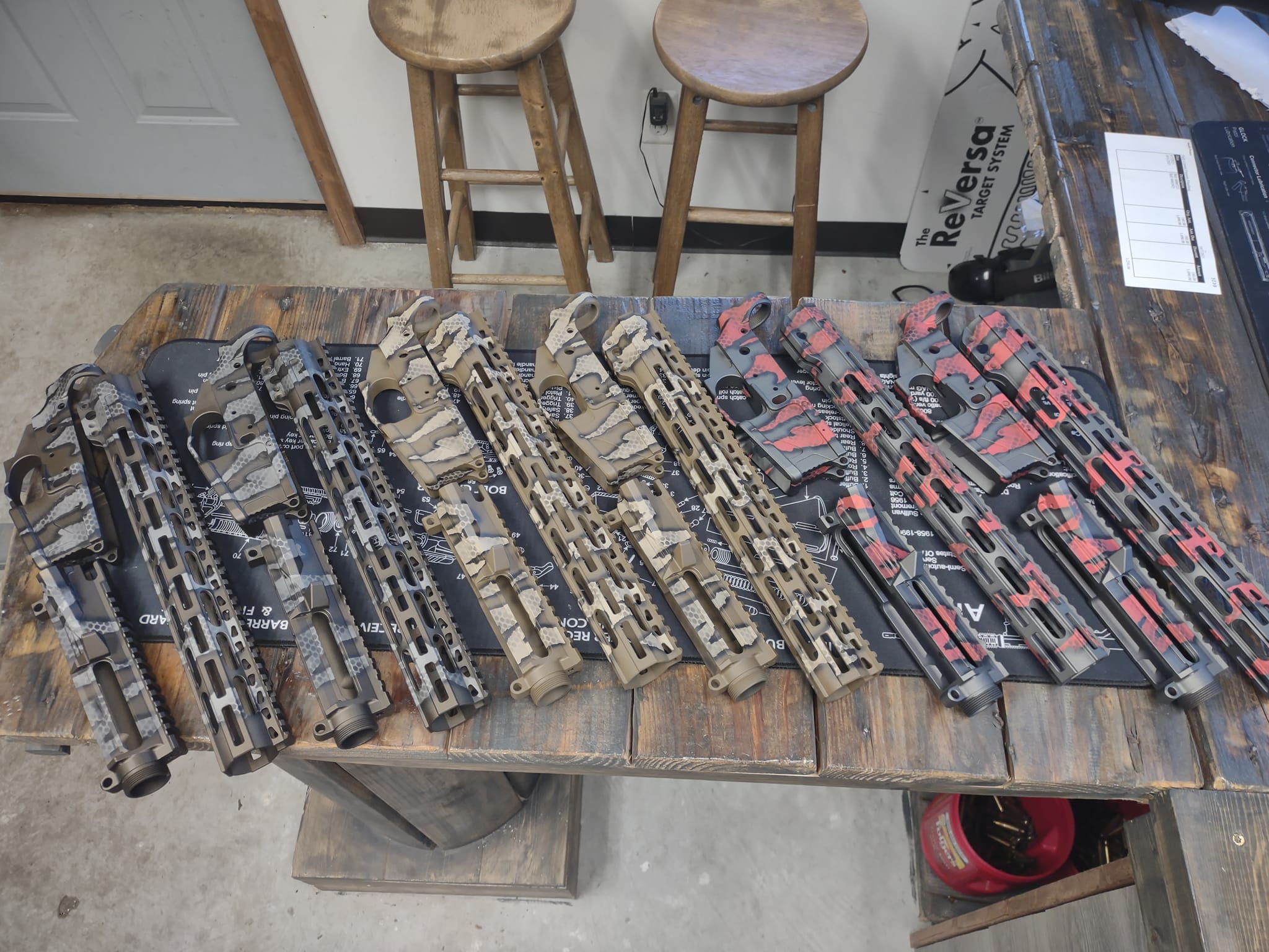 Row of completed cerakote builds on workbench